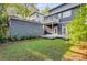 A charming backyard with a small lawn area, a wooden deck and a detached gray brick garage at 327 6Th Ne St, Atlanta, GA 30308