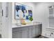 Basement bar area featuring gray cabinets, counter, and a stylish abstract painting at 327 6Th Ne St, Atlanta, GA 30308