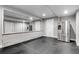 Unfinished basement with a large mirror, exposed foundation, and a stainless steel refrigerator at 327 6Th Ne St, Atlanta, GA 30308