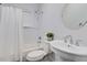 Cozy bathroom with a white tub, shower, toilet, and a round mirror above a white sink at 327 6Th Ne St, Atlanta, GA 30308