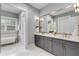 Beautiful bathroom with double sink vanity, tiled floors, large mirror and separate tub at 327 6Th Ne St, Atlanta, GA 30308