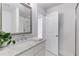 Bright bathroom with marble countertop, white cabinetry, and glass shower at 327 6Th Ne St, Atlanta, GA 30308