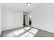 Bright bedroom featuring neutral carpet, large closet, and an ensuite bathroom view at 327 6Th Ne St, Atlanta, GA 30308