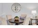 Cozy dining area features a round table, comfortable chairs, a decorative mirror, and a stylish table lamp at 327 6Th Ne St, Atlanta, GA 30308