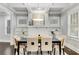 Bright dining room with coffered ceilings, a modern chandelier, and a stylish table setting at 327 6Th Ne St, Atlanta, GA 30308