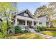 A charming home with a welcoming front porch, stone stairs, and lush landscaping at 327 6Th Ne St, Atlanta, GA 30308