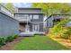 Rear exterior view of home with a deck and seating area overlooking a fenced yard and lawn at 327 6Th Ne St, Atlanta, GA 30308
