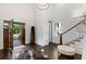 Elegant foyer with hardwood floors, featuring a striking light fixture, staircase, and abundant natural light at 327 6Th Ne St, Atlanta, GA 30308