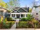Attractive home with a well-manicured front yard, framed by a stylish fence and a walkway leading to a welcoming porch at 327 6Th Ne St, Atlanta, GA 30308