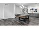Spacious game room featuring a stylish pool table, modern lighting, wet bar, and sleek flooring at 327 6Th Ne St, Atlanta, GA 30308