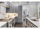 Modern kitchen featuring grey cabinets, stainless appliances, and white marble backsplash at 327 6Th Ne St, Atlanta, GA 30308