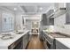 Spacious kitchen featuring stainless steel appliances, island with seating, and an open floorplan at 327 6Th Ne St, Atlanta, GA 30308