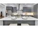 Kitchen island features a white countertop, grey base, seating, and a gold faucet at 327 6Th Ne St, Atlanta, GA 30308
