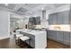 Modern kitchen with gray cabinets, stainless steel appliances, an island and an open floorplan at 327 6Th Ne St, Atlanta, GA 30308