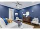 This primary bedroom features hardwood floors, a large bed, and two accent chairs at 327 6Th Ne St, Atlanta, GA 30308