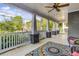Inviting covered porch with ceiling fan, offering a relaxing outdoor space with patterned rug and furniture at 327 6Th Ne St, Atlanta, GA 30308