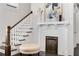 Beautiful staircase complemented by a decorative fireplace with white mantel and herringbone tile at 327 6Th Ne St, Atlanta, GA 30308