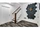 Inviting entrance foyer with a staircase, dark flooring, paneled door and dart board at 327 6Th Ne St, Atlanta, GA 30308