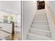 Stairway leading to an office space with hardwood floors and large windows at 327 6Th Ne St, Atlanta, GA 30308