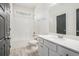Bright bathroom featuring a white vanity, modern sink, and a shower-tub combination at 1600 Kamp Springs Ave, Lawrenceville, GA 30045
