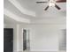 Modern bedroom boasting a tray ceiling, ceiling fan and views of a bath at 1600 Kamp Springs Ave, Lawrenceville, GA 30045