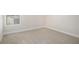 Neutral bedroom with soft carpet, a window, and white trim at 1600 Kamp Springs Ave, Lawrenceville, GA 30045