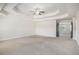 Large carpeted bedroom featuring tray ceiling, recessed lighting, and multiple doors at 1600 Kamp Springs Ave, Lawrenceville, GA 30045
