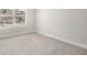 Carpeted bedroom with neutral walls, a window to view outside and minimalist style at 1600 Kamp Springs Ave, Lawrenceville, GA 30045
