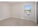 Cozy bedroom with neutral carpet and a window offering natural light at 1600 Kamp Springs Ave, Lawrenceville, GA 30045