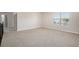 Spacious bedroom area filled with carpet, a window and a view of the roof of another home at 1600 Kamp Springs Ave, Lawrenceville, GA 30045