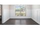 Bright dining room featuring wainscoting, hardwood floors, chandelier, and large window with view at 1600 Kamp Springs Ave, Lawrenceville, GA 30045