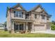 Charming two-story home with brick and siding exterior, front lawn, and three-car garage at 1600 Kamp Springs Ave, Lawrenceville, GA 30045