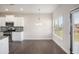 Well-lit kitchen with white cabinets, stainless steel appliances, and a cozy breakfast nook at 1600 Kamp Springs Ave, Lawrenceville, GA 30045