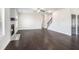 Expansive living area with fireplace, hardwood floors, staircase, and neutral color palette at 1600 Kamp Springs Ave, Lawrenceville, GA 30045