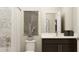 Stylish bathroom with modern fixtures, dark wood vanity, white marble countertop and a shower-tub combo at 2450 Cotton Ln, Douglasville, GA 30135