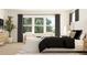 Bedroom features a plush bed, accent chairs, and large windows with natural light at 2450 Cotton Ln, Douglasville, GA 30135