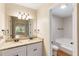 Bathroom featuring a double sink vanity with granite countertop and a separate toilet and tub at 639 Ladora Dr, Dallas, GA 30157