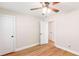 Bedroom with wood floors, neutral walls, and a view into another room with two closets at 639 Ladora Dr, Dallas, GA 30157