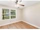 Bedroom featuring a window with treelined view, ceiling fan, and wood floors at 639 Ladora Dr, Dallas, GA 30157