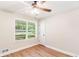 This cozy bedroom has a ceiling fan, wood-look flooring, and a large window for plenty of natural light at 639 Ladora Dr, Dallas, GA 30157