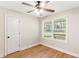 Bedroom featuring wood floors, a window with treelined view, and a door at 639 Ladora Dr, Dallas, GA 30157