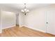 Dining area features hardwood floors, modern chandelier, and white trim at 639 Ladora Dr, Dallas, GA 30157