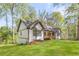 A charming single-story house on a green lawn featuring a cozy porch, perfect for outdoor relaxation at 639 Ladora Dr, Dallas, GA 30157
