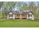Charming single story home featuring a large, well-manicured front lawn and a welcoming front porch at 639 Ladora Dr, Dallas, GA 30157