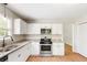 Bright kitchen features stainless steel appliances, granite countertops, and white cabinets at 639 Ladora Dr, Dallas, GA 30157
