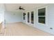 Large outdoor deck with ceiling fan, surrounded by siding, windows, and doors at 6585 Rhett Run, Cumming, GA 30028
