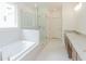 Bright bathroom with a soaking tub, glass shower, and double vanity sinks at 6585 Rhett Run, Cumming, GA 30028