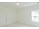 Bedroom with window and five-panel door at 6585 Rhett Run, Cumming, GA 30028