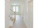 Bright entryway featuring light wood floors, white walls, and double doors at 6585 Rhett Run, Cumming, GA 30028