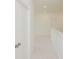 Bright hallway with neutral carpet, white walls, and a five-panel door at 6585 Rhett Run, Cumming, GA 30028